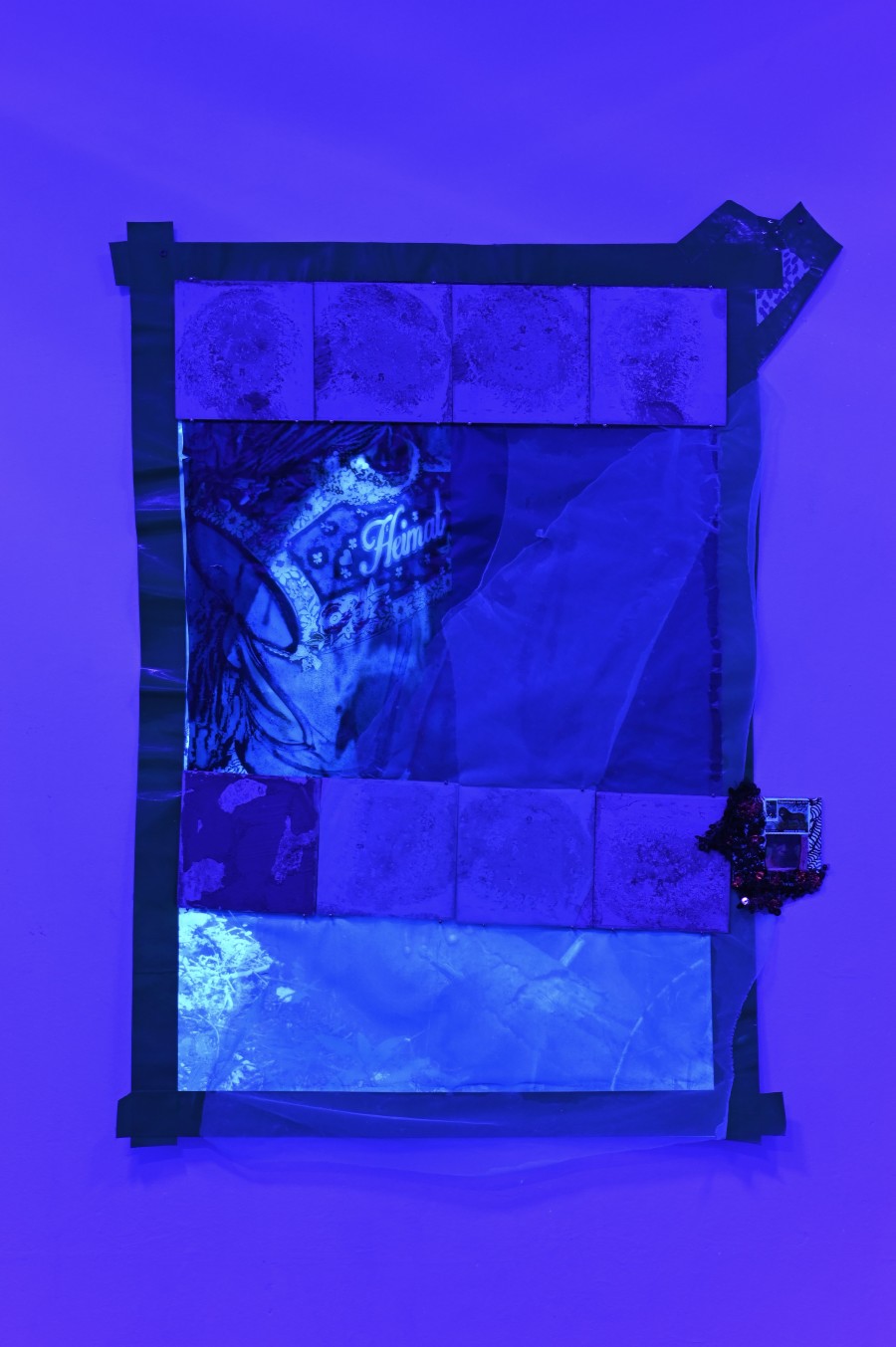 "Heimat 1," 2024/2026, Mixed media, print on fabric, pergament paper, ceramic tiles, tape, 104 x 67,5 cm. "Shi Deh Deh" by Jasmine Tutum at Kaiserwache, Freiburg im Breisgau, 2026. Photo by Stefan Lux.